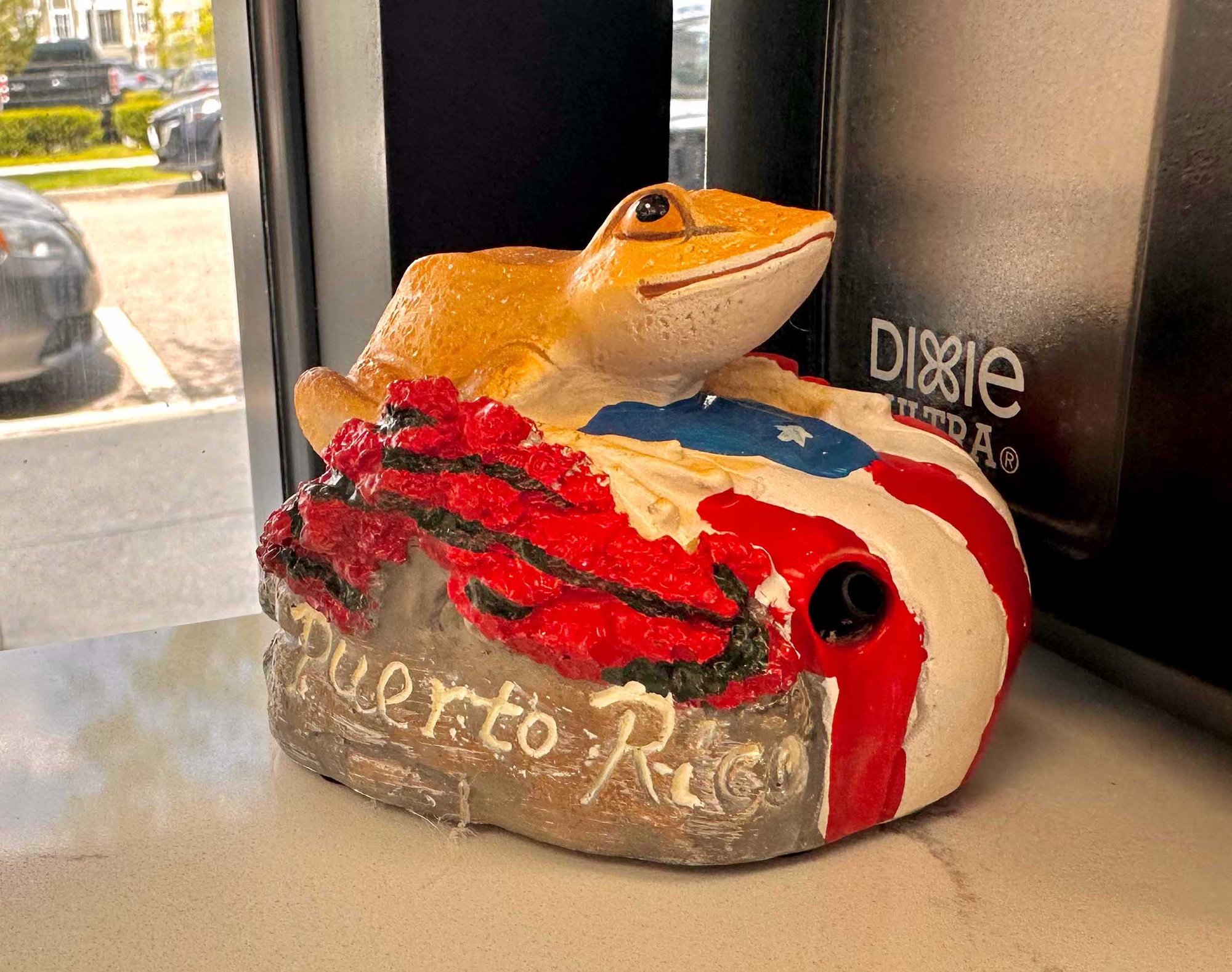 small frog figure with puerto rican flag